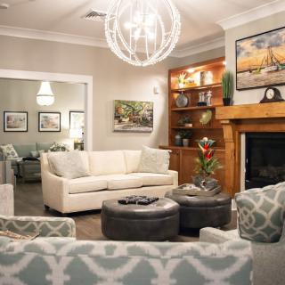A stylish living room featuring a modern design with comfortable seating, warm lighting, and elegant decor.