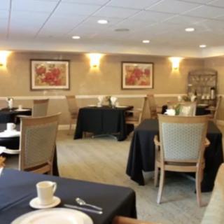 A well-lit dining area with elegantly set tables and chairs.