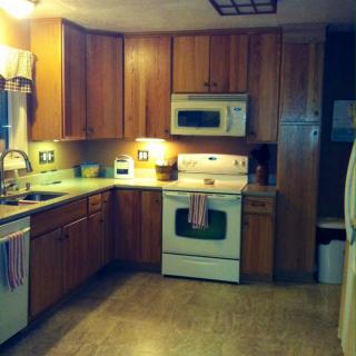 A spacious kitchen with wooden cabinets, modern appliances, and ample counter space.