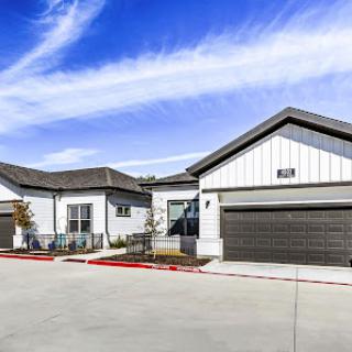 A row of modern single-family homes under a clear blue sky.