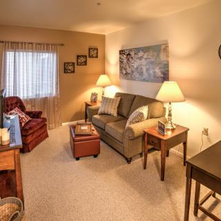 A cozy living room with warm lighting and comfortable seating.