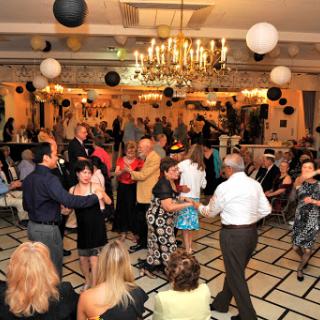 A lively dance party in an elegantly decorated venue.