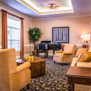 A cozy living room interior with sofas, a table, and elegant decor.