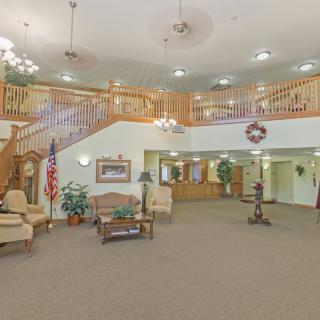 Spacious lobby with a staircase and elegant decor.