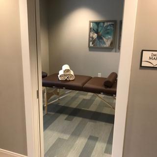 A peaceful massage room featuring a therapy table and calming decor.