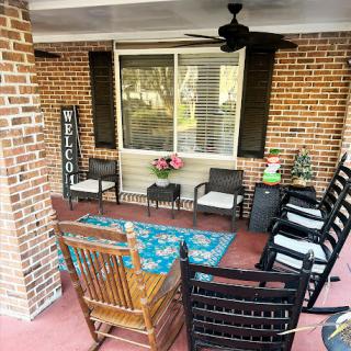 A cozy and inviting porch perfect for relaxation with comfortable seating and decorative elements.
