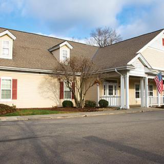 A suburban-style building with a driveway and an American flag displayed.