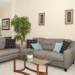 A cozy living room setup featuring comfortable sofas and stylish decor.