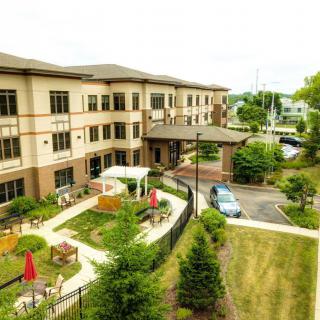 A modern residential building with a landscaped garden area.