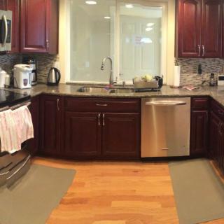 A modern kitchen with wooden cabinets and stainless steel appliances.