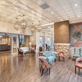 A spacious and elegantly designed lobby featuring modern furniture and stylish lighting.