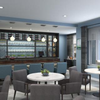 A modern restaurant interior featuring a bar and seating area with contemporary furniture.