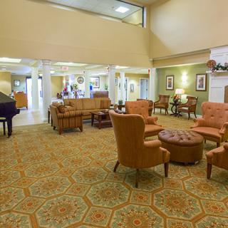A spacious lobby with comfortable seating, a grand piano, and elegant decor.