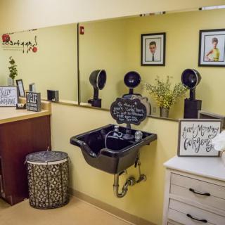 A well-decorated salon interior with a sink and mirrors.