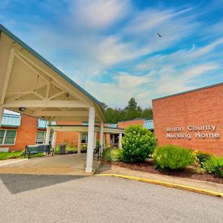 A view of a medical center, showcasing its entrance and surrounding landscape.