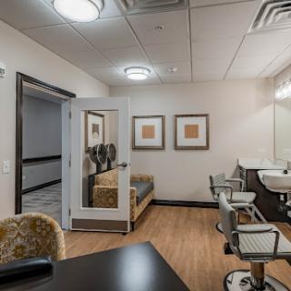 A modern and stylish interior of a salon, featuring hair styling stations and a cozy waiting area.