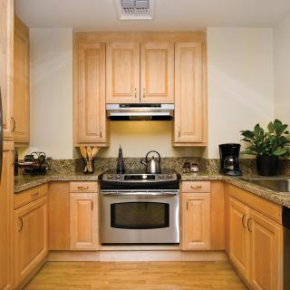 A modern kitchen with wooden cabinets and stainless steel appliances.