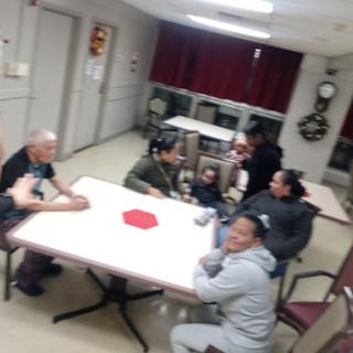 A friendly gathering of individuals around a table.