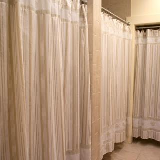 A row of shower curtains in a bathroom, providing privacy for users.