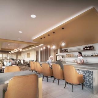 A modern restaurant interior featuring a bar with stylish seating and ambient lighting.