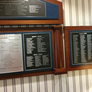 A display board showcasing a menu or list of items available, likely found in a restaurant or dining area.