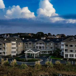 A scenic view of a large residential complex under a cloudy sky.
