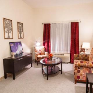 A cozy living room with contemporary furniture and warm decor.