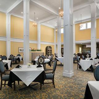 An elegant and spacious dining room with neatly set tables and stylish decor.