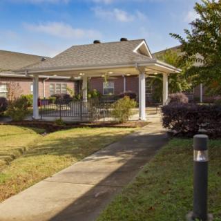A charming residential home with a covered porch and well-maintained garden.
