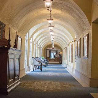 A beautifully lit hallway with an arched ceiling and decorative elements.