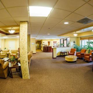 A spacious lobby featuring comfortable seating and warm lighting.