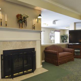 A cozy living room with a fireplace and comfortable seating area.