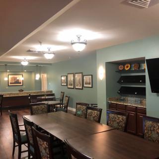 A modern dining or meeting area with a large table, stylish chairs, and ambient lighting.