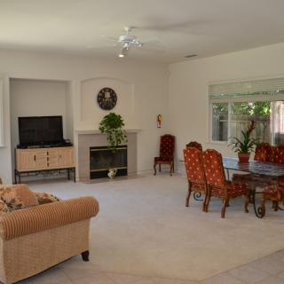 Spacious living room with cozy furnishings and a fireplace.