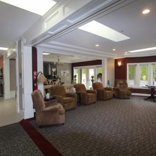 A spacious living room with comfortable seating and natural lighting.
