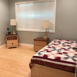 A minimalist bedroom with a bed, nightstands, and lamps.