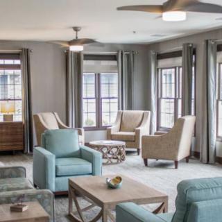 A modern living room with comfortable seating and large windows.