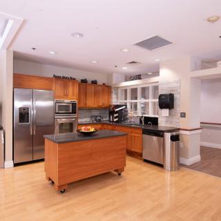 A modern kitchen with stainless steel appliances and a central island.