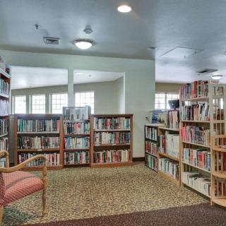 A cozy library corner with bookshelves and a reading chair.