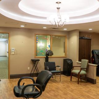 A modern waiting room with comfortable seating and stylish lighting.