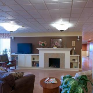 A cozy living room featuring a fireplace and television with comfortable seating.