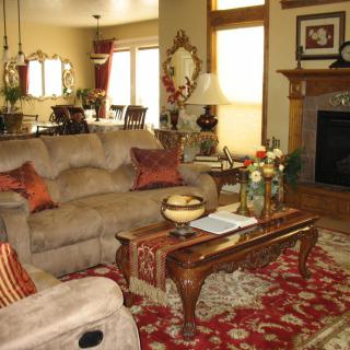 A cozy living room with a plush sofa, ornate coffee table, and a decorative rug.