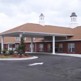 An exterior view of a healthcare facility with a covered entrance.