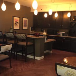 Modern kitchen with pendant lighting and a bar seating area.