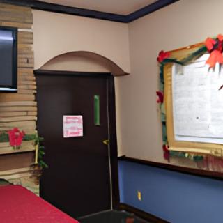 A restaurant interior decorated with holiday-themed elements, including poinsettias and a framed menu board.