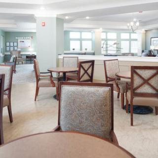A spacious and modern dining area with neatly arranged tables and chairs.