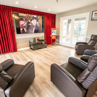 Modern home theater with comfortable seating and a large screen.