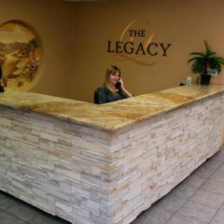 A woman at a reception desk in an office setting.