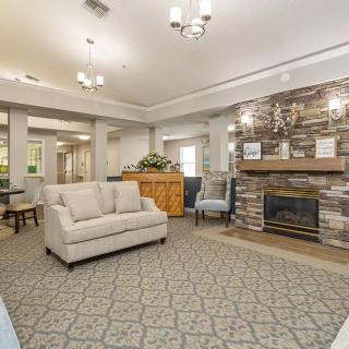 A cozy living room featuring a comfortable sofa and a stone fireplace.
