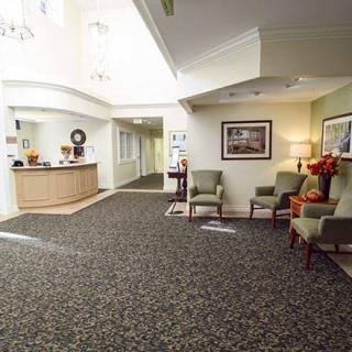 A well-lit lobby with a reception desk and comfortable seating area.